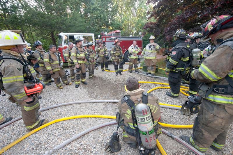 Chief Mark Bennett leads the crew in a discussion after the evolution.
Photo Credit Mike Heller